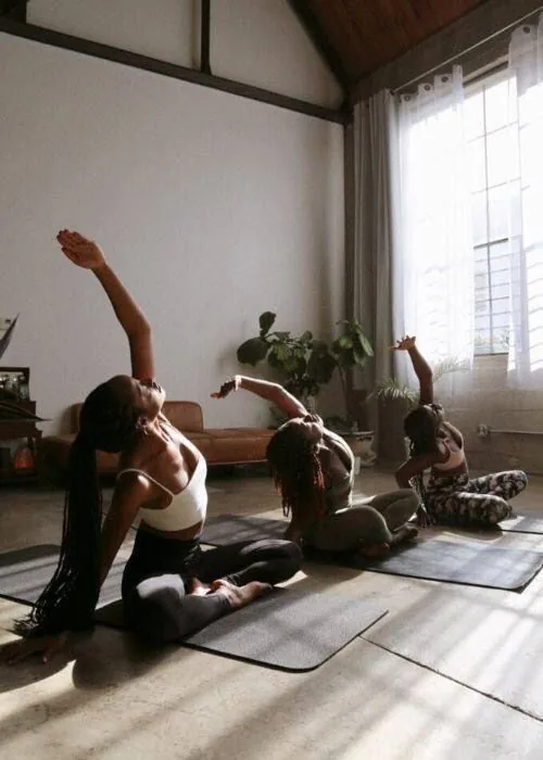 A class stretching in front of a bright window